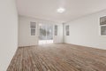 Raw Unfinished Room of House with Blank White Walls and Worn Wood Floors