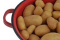 Potatoes in a red colander Royalty Free Stock Photo