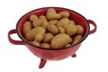 Potatoes in a red colandersolated on white Royalty Free Stock Photo