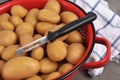 Closeup on peeler with potatoes ia colander Royalty Free Stock Photo