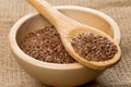 Raw, unprocessed linseed or flax seed in wooden bowl and wood sp