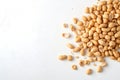 Raw unsalted peanuts scattered on a white surface in natural light highlighting their texture and color during daytime Royalty Free Stock Photo