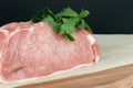 Raw veal meat fillet on kitchen cutting board and on parchment paperwith seasoning Royalty Free Stock Photo