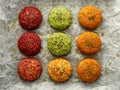 Raw vegan burgers made of beetroot, green peas, carrots, groats and herbs on white parchment prepared for baking, top view. Royalty Free Stock Photo