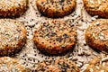 Raw vegan burgers made of carrots, millet, mix of seeds and herbs  on  parchment prepared for baking, close-up. Royalty Free Stock Photo