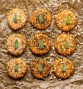 Raw vegan burgers made of carrots, millet, mix of seeds and herbs  on  parchment prepared for baking, top view. Royalty Free Stock Photo