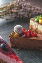 Raw vegan cakes with fruit and seeds, decorated with flower, product photography for patisserie Royalty Free Stock Photo