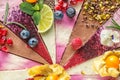 Raw vegan cakes with fruit and seeds, decorated with flower, product photography for patisserie Royalty Free Stock Photo