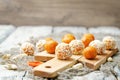 Raw vegan cashew dried apricots, coconut balls on a wood background Royalty Free Stock Photo