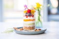 raw vegan cheesecake in a glass jar with layered fruit and nuts