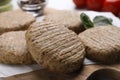 Raw vegan cutlets on wooden board, closeup