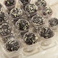 Raw vegan dessert as brown balls in plastic box Royalty Free Stock Photo