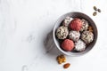 Raw vegan dessert. Energy balls. Truffles made from nuts, seeds, cocoa, dates and superfood powders, white marble background Royalty Free Stock Photo