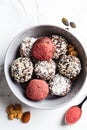 Raw vegan dessert. Energy balls. Truffles made from nuts, seeds, cocoa, dates and superfood powders, white marble background Royalty Free Stock Photo