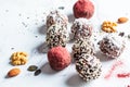 Raw vegan dessert. Energy balls. Truffles made from nuts, seeds, cocoa, dates and superfood powders, white marble background Royalty Free Stock Photo