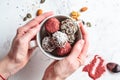 Raw vegan dessert. Energy balls. Truffles made from nuts, seeds, cocoa, dates and superfood powders, white marble background Royalty Free Stock Photo