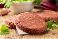 Raw Vegan meat free cutlets, burger on wooden board. ready to cook