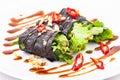 Raw vegan nori hand rolls with sauce, salad and vegetables. Vegetarian, gluten-free food Royalty Free Stock Photo