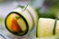 Raw vegan rolls with sprouted seeds,radish, cucumber, parsley and carrots on glass plate