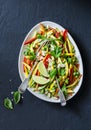 Raw vegetables Pad Thai salad on dark background, top view. Vegetarian healthy food. Royalty Free Stock Photo