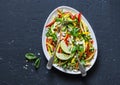 Raw vegetables Pad Thai salad on dark background, top view. Vegetarian healthy food. Royalty Free Stock Photo