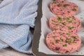 Raw veggie burger with beetroot and white beans with parsley leaves on wood cutting board Royalty Free Stock Photo