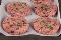 Raw veggie burger with beetroot and white beans with parsley leaves on wood cutting board Royalty Free Stock Photo