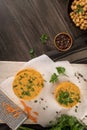 Raw veggie burger with chickpeas, vegetables and parsley leaves on kitchen countertop Royalty Free Stock Photo