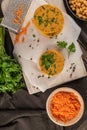 Raw veggie burger with chickpeas, vegetables and parsley leaves on kitchen countertop Royalty Free Stock Photo