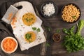 Raw veggie burger with chickpeas, vegetables and parsley leaves on kitchen countertop Royalty Free Stock Photo