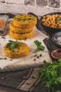 Raw veggie burger with chickpeas, vegetables and parsley leaves on kitchen countertop Royalty Free Stock Photo