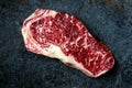 Raw Wagyu beef striploin steak on stone table. Royalty Free Stock Photo