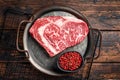 Raw wagyu rib eye beef meat steak in steel tray. Wooden background. Top view Royalty Free Stock Photo