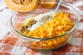 Raw washed millet, rice, raisins and pumpkin in a glass pan in the process of cooking milk porridge Royalty Free Stock Photo