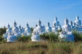 raw of white buddha status on blue sky background Royalty Free Stock Photo