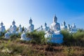 raw of white buddha status on blue sky background Royalty Free Stock Photo