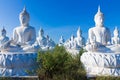 Raw of white buddha status on blue sky background Royalty Free Stock Photo