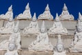 Raw of white buddha status on the wall Royalty Free Stock Photo
