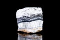 Raw white calcite mineral stone in front of black background