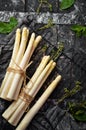 Raw white fresh asparagus on a black stone background. Healthy food. Top view. Free space for your text Royalty Free Stock Photo