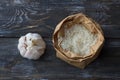 Raw white long-grain basmati rice in a craft bag with garlic on a wooden table Royalty Free Stock Photo