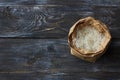 Raw white long-grain basmati rice in a craft bag on a wooden background Royalty Free Stock Photo