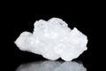 Raw white quartz mineral stone in front of black background Royalty Free Stock Photo