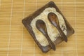 Raw white rice on a square wooden plate and two wooden spoons with rice on a bamboo napkin for healthy eating, vegetarianism, top