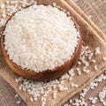 Raw white rice in a wooden bowl over table Royalty Free Stock Photo