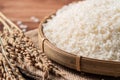 Raw white rice in a wooden bowl over table Royalty Free Stock Photo