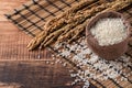 Raw white rice in a wooden bowl over table Royalty Free Stock Photo