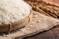 Raw white rice in a wooden bowl over table Royalty Free Stock Photo
