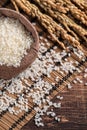 Raw white rice in a wooden bowl over table Royalty Free Stock Photo