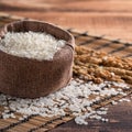 Raw white rice in a wooden bowl over table Royalty Free Stock Photo